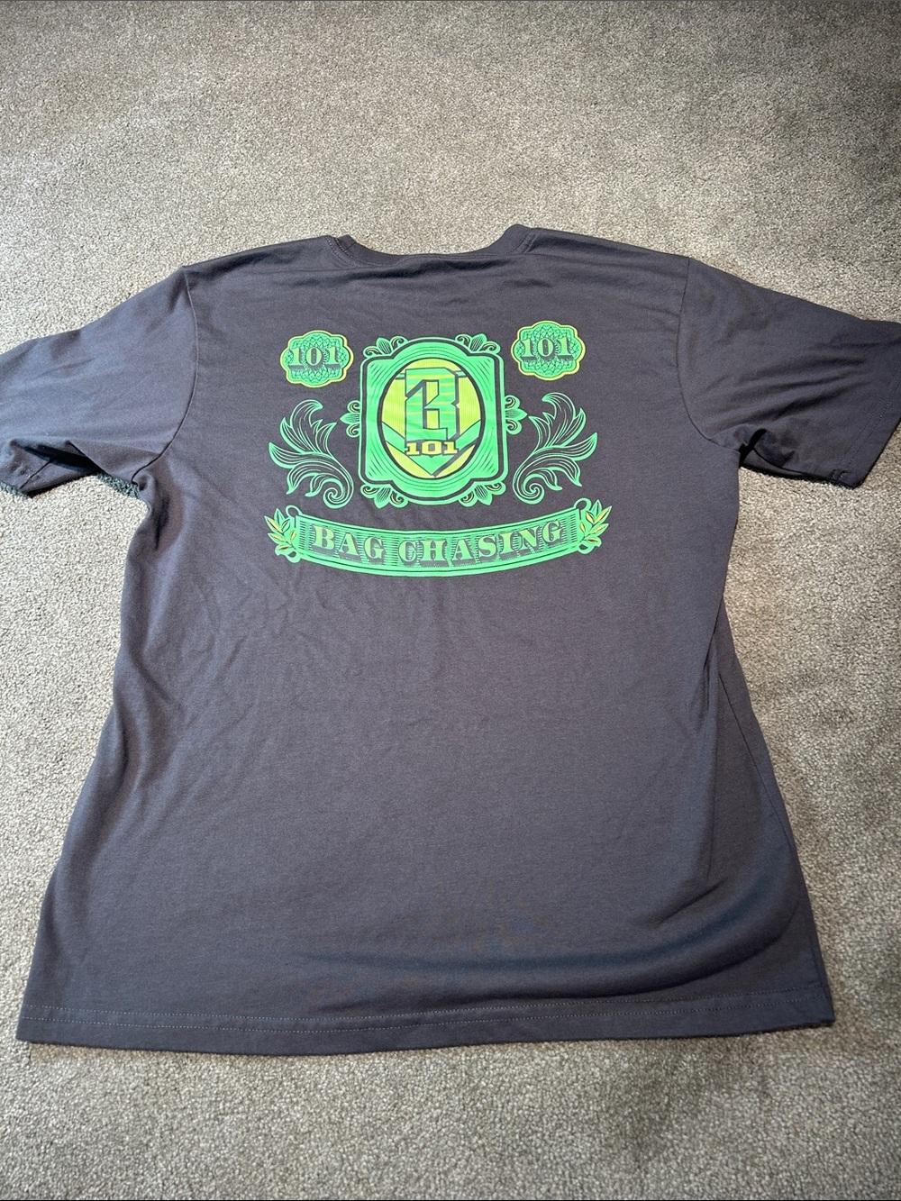 Black Short-Sleeve Tee with Green 'Bag Chasing' Graphic